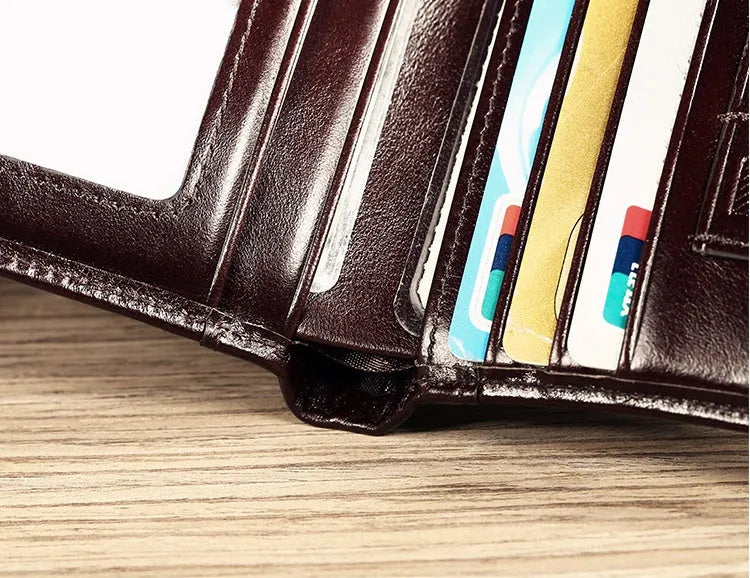 Men's black leather wallet open to show photo window, card slots, coin pocket and banknote folder.