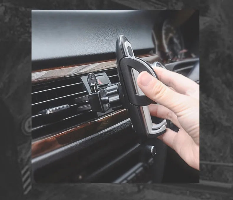 Black car phone holder clipped to air conditioning vent with smartphone secured in adjustable bracket