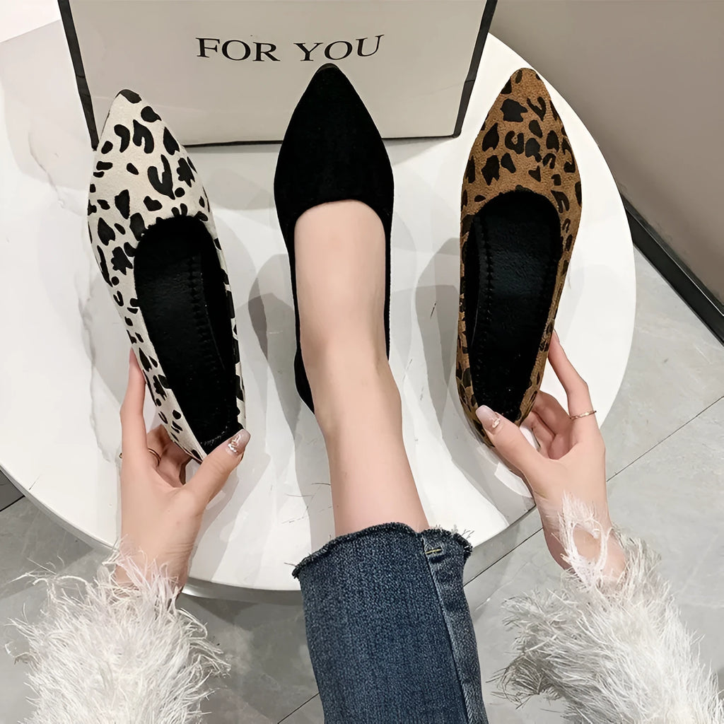 Women's leopard print pointed toe flat pumps with low heel on a white background.