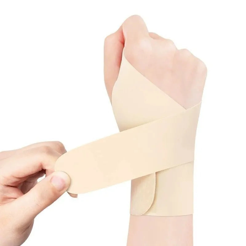 Adjustable athletic wristguard in black on a wrist, showing Velcro strap closure.