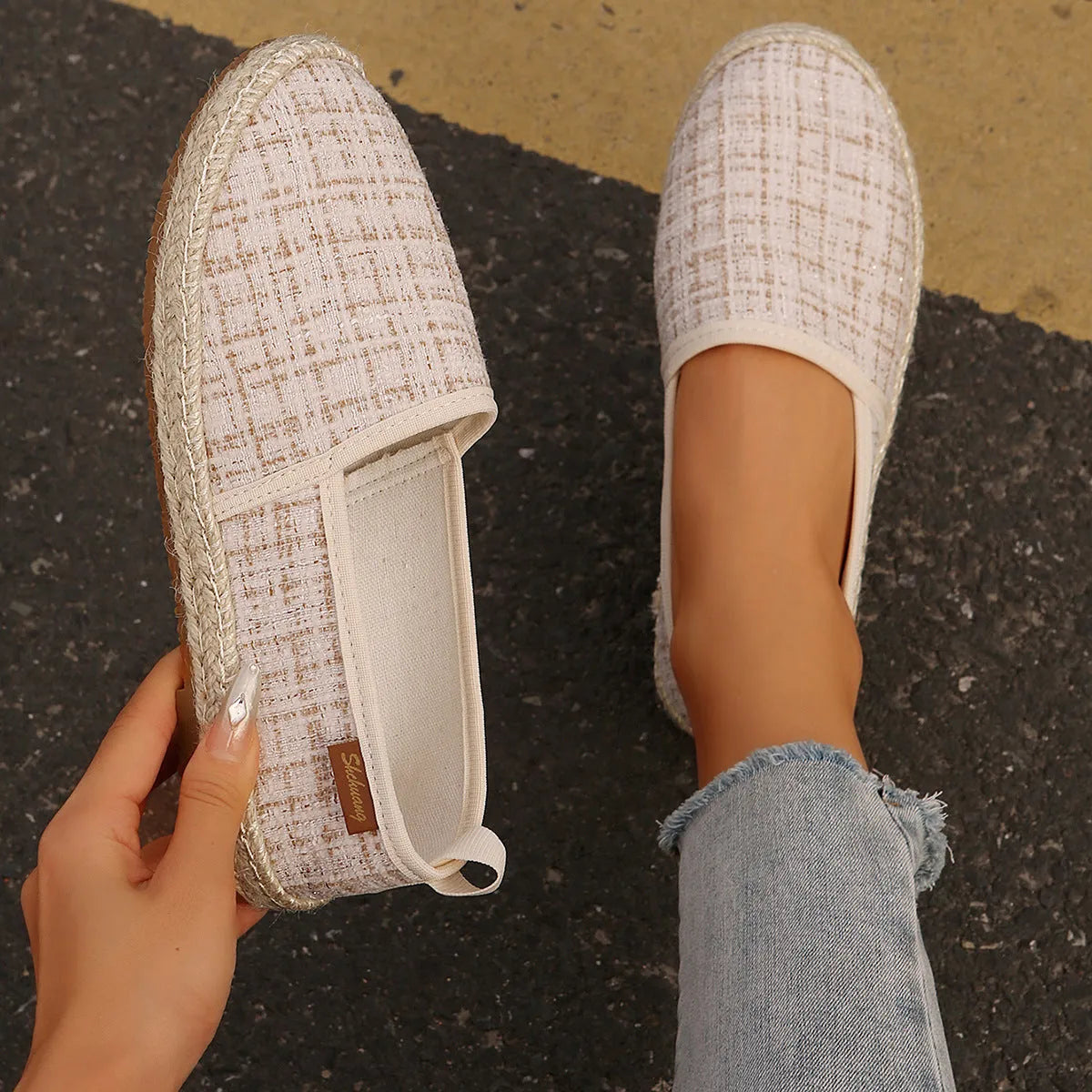 Beige fisherman shoes with canvas upper and rope sole on a flat background