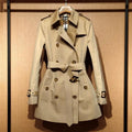 Women's khaki British double-breasted trench coat with flight sleeves on hanger
