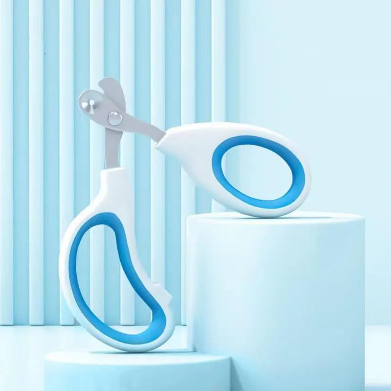 Blue pet nail clippers with a circular cutting hole and cushioned non-slip handles.