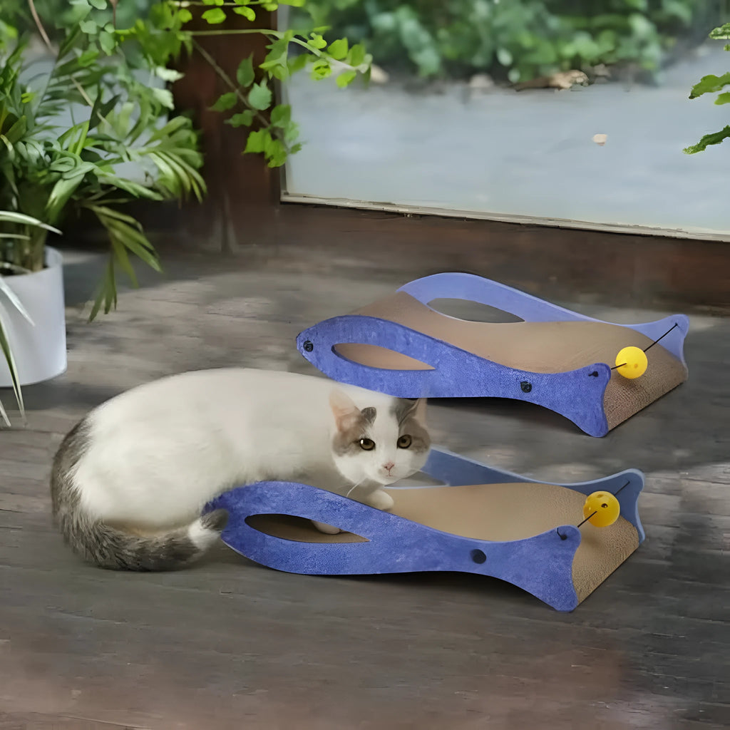 Blue fish-shaped cardboard cat scratcher lounger with a dangling bell toy for indoor cats.