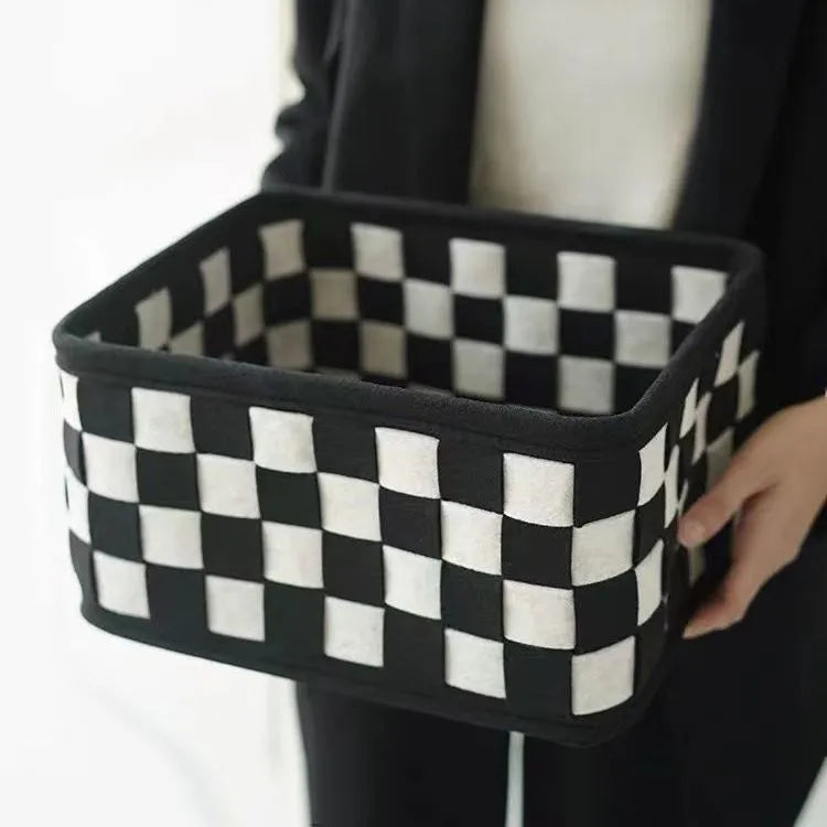 Checkerboard patterned folding felt storage basket showing collapsible sides.