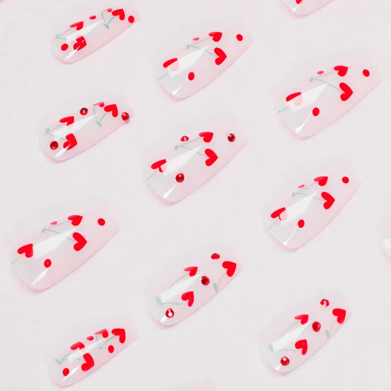French-style red diamond and small cherry design nail art armour sheets and glue tube.