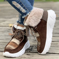 Women's beige lace-up snow boots with a suede upper and thick platform sole.