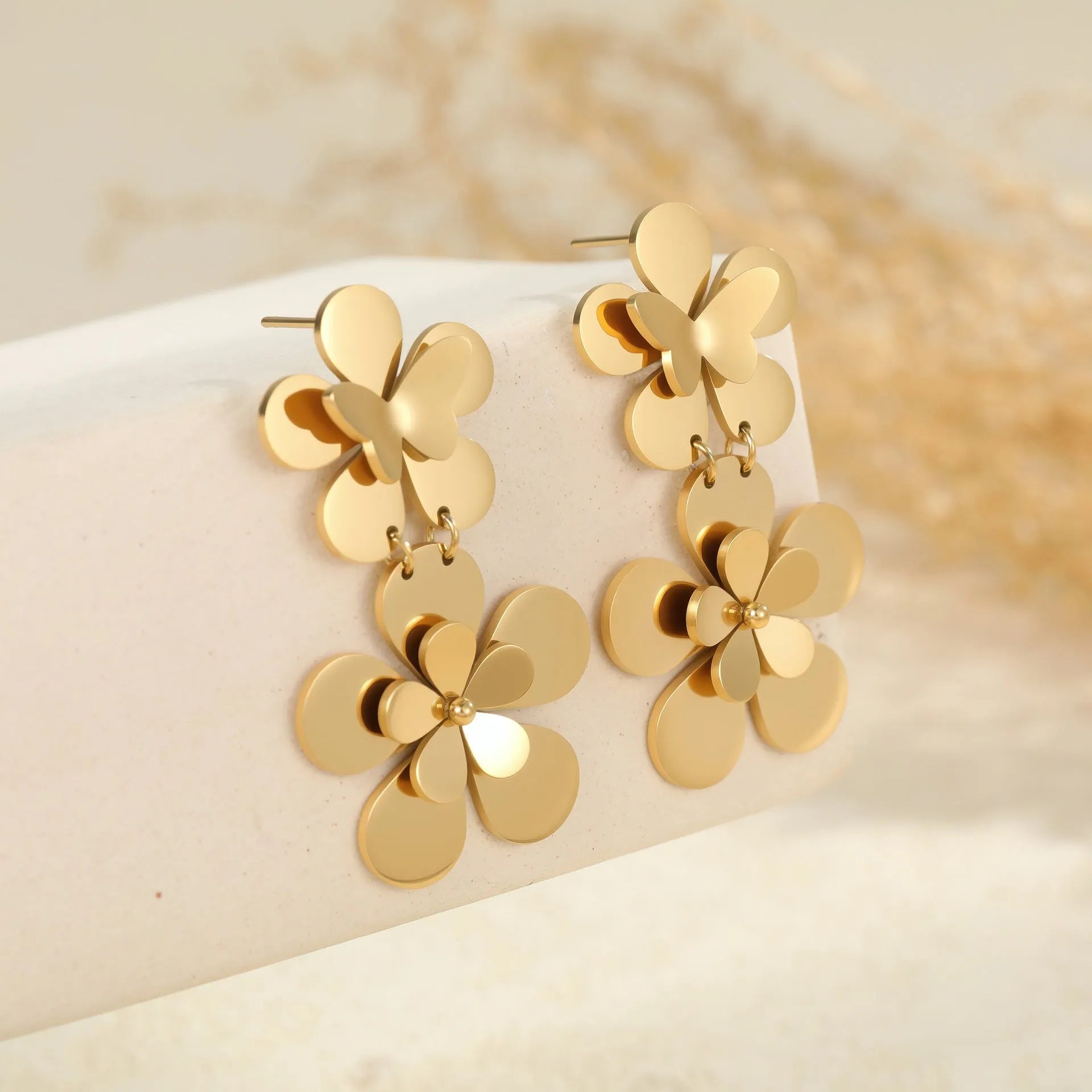 Gold-coloured stainless steel butterfly flower earrings with geometric and zodiac design elements