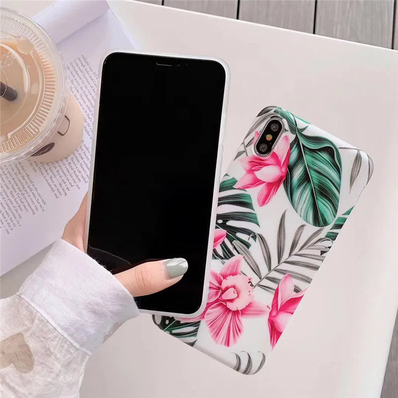 Pink floral TPU phone case for iPhone models on a table