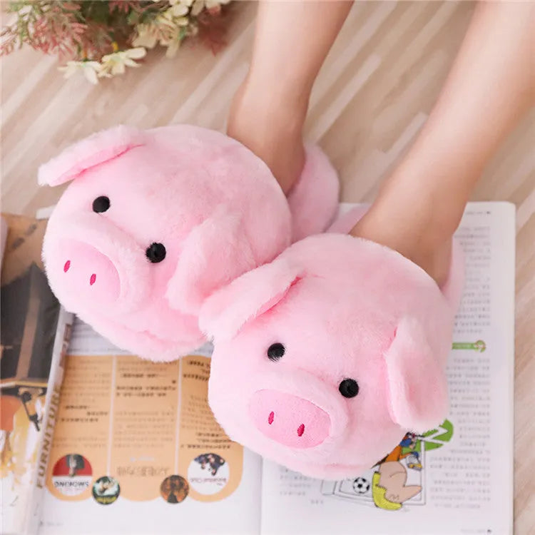 Pink pig-shaped plush floor slippers with short plush exterior.