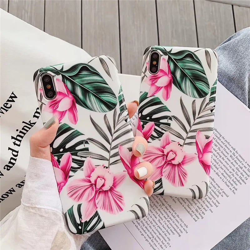 Pink floral TPU phone case for iPhone models on a table