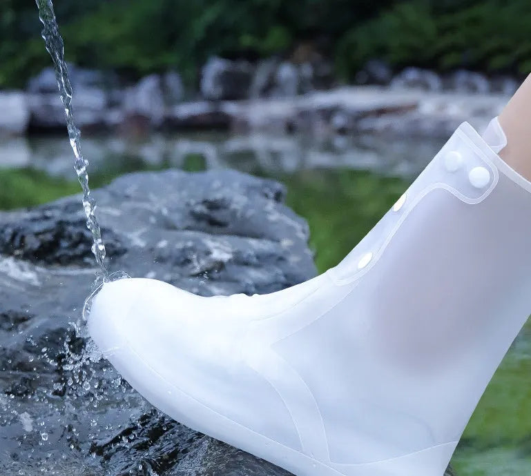 White PVC high-top reusable waterproof shoe cover for women, shown on a foot.