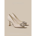 Creamy-white or black women's pointed toe high heels with a stiletto heel on a plain background.
