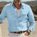 Man wearing a loose-fit green cotton long-sleeved summer shirt.