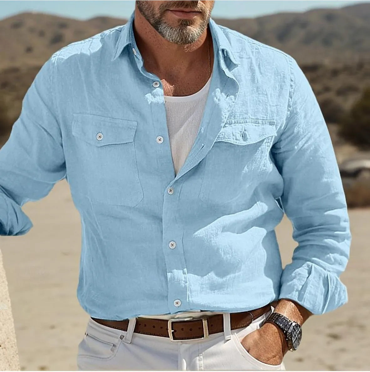 Man wearing a loose-fit green cotton long-sleeved summer shirt.