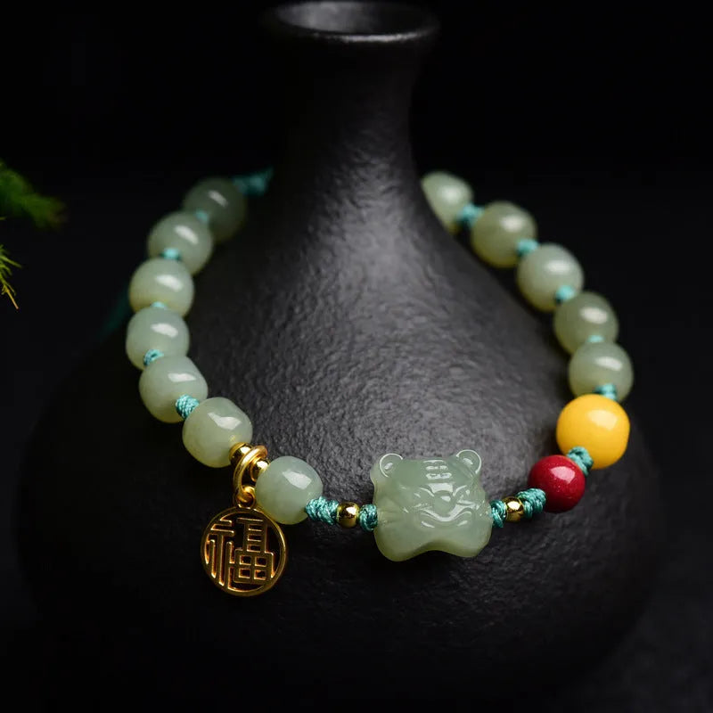 Natural Hetian Jade bracelet with cinnabar and beeswax beads, animal zodiac motifs, and sequin details on a string