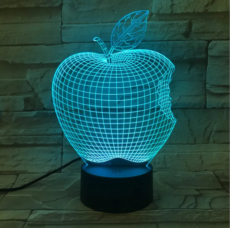 3D fruit-shaped colourful night light with acrylic shade and touch control on a surface.