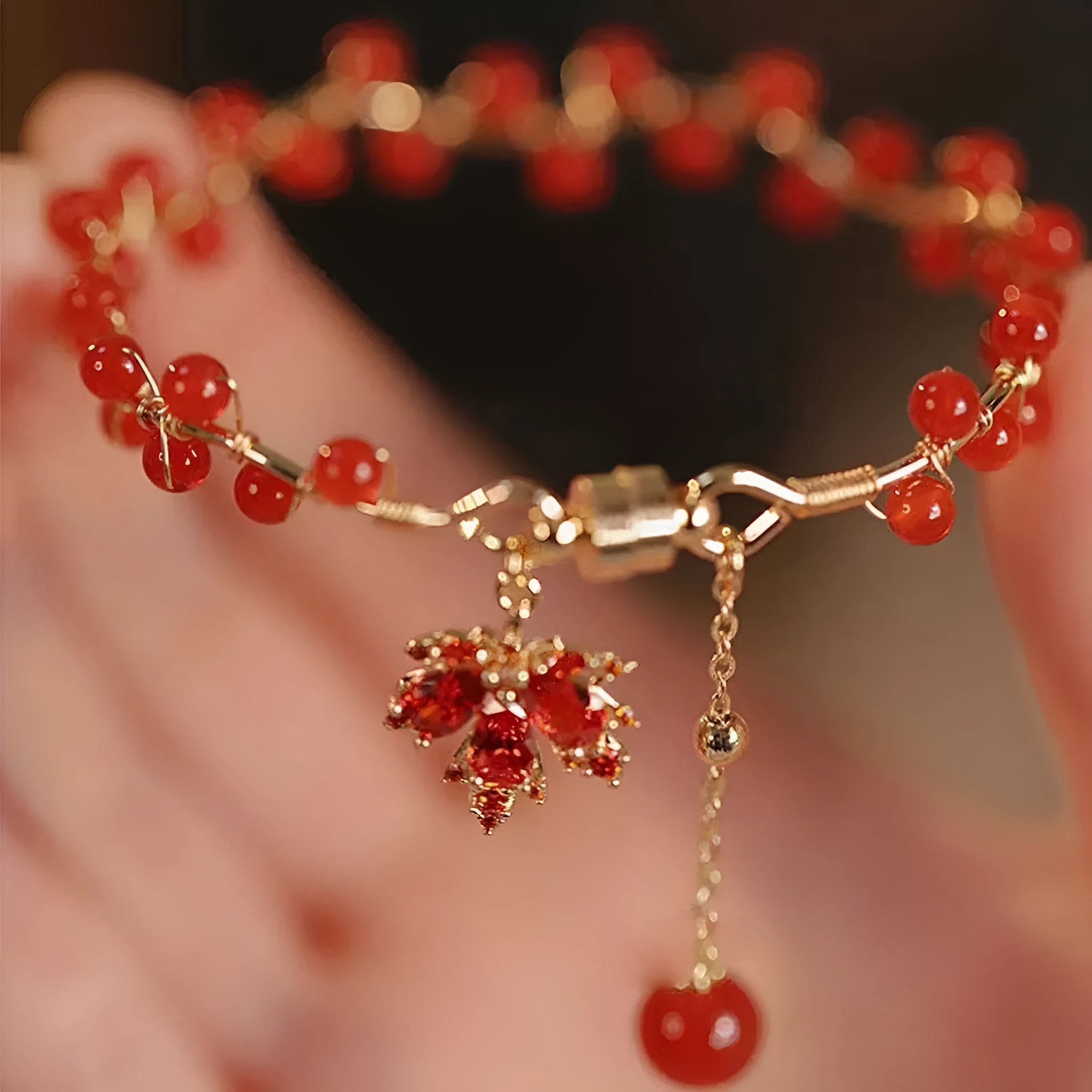 Red ginkgo leaf charm on a silver-toned magnetic alloy bracelet in Chinese natural style.
