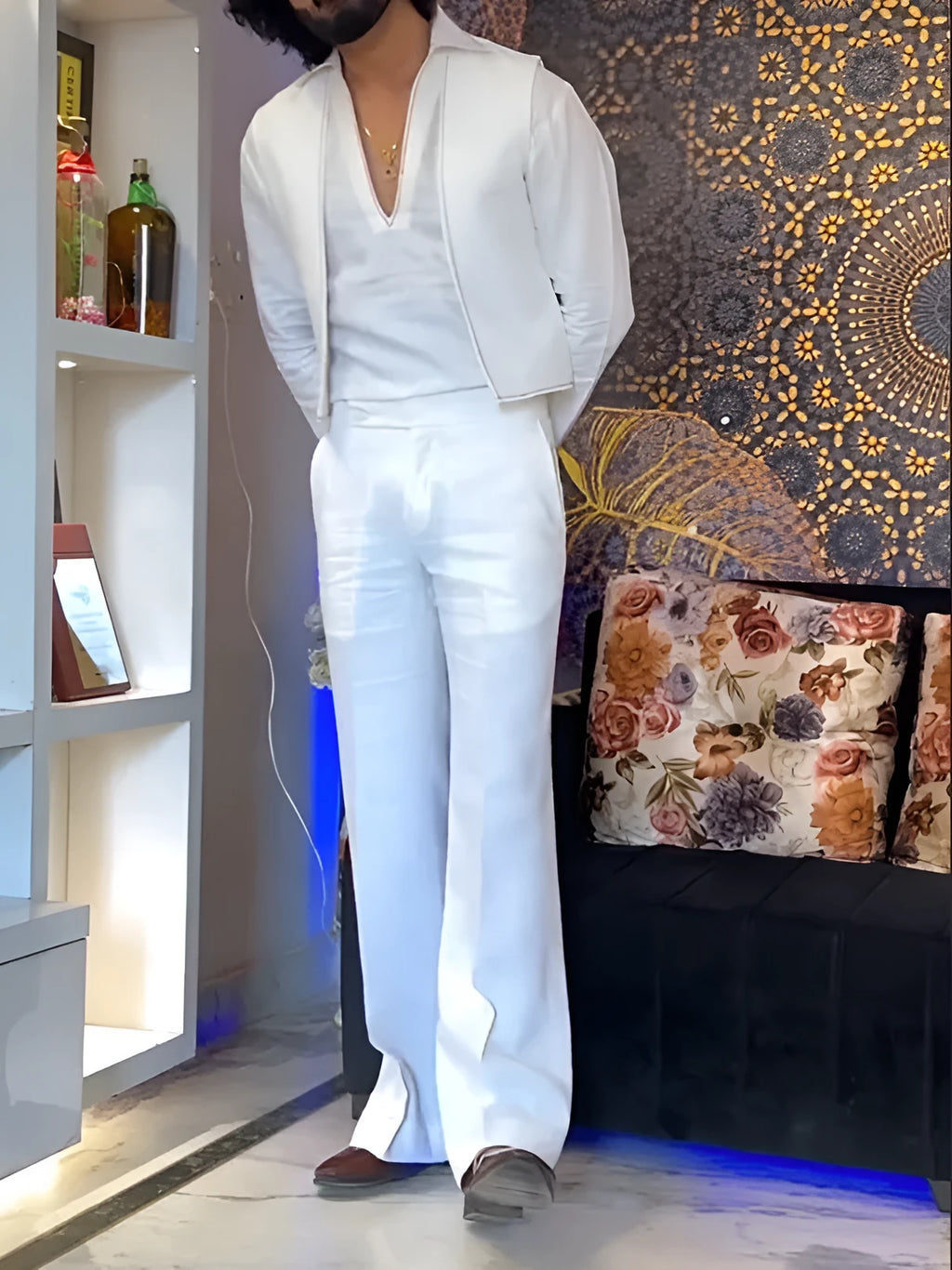 White three-piece outfit showing V-neck shirt, sleeveless vest, and full-length trousers laid flat