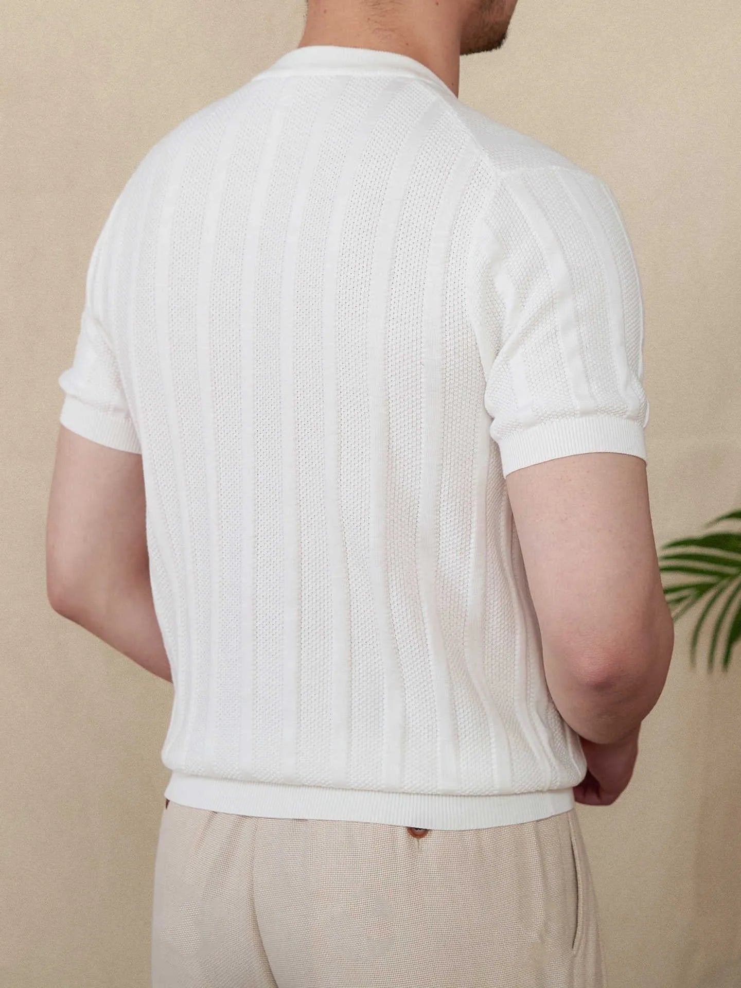 Men's creamy-white Henry collar cotton T-shirt with sunken stripe design on thin fabric.
