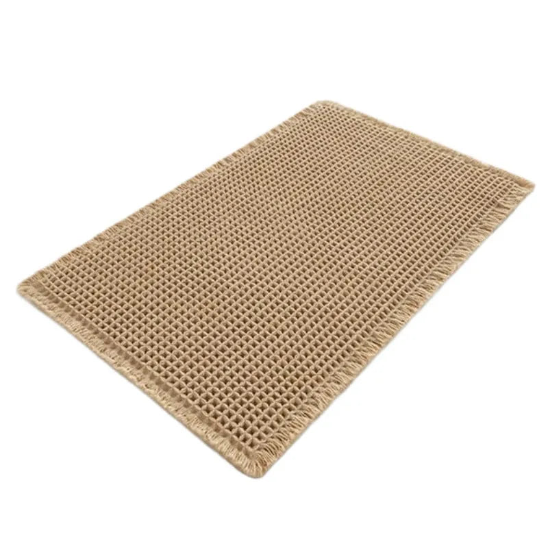 Checkered patterned absorbent bathroom carpet on floor showing non-slip woven base in beige colour.