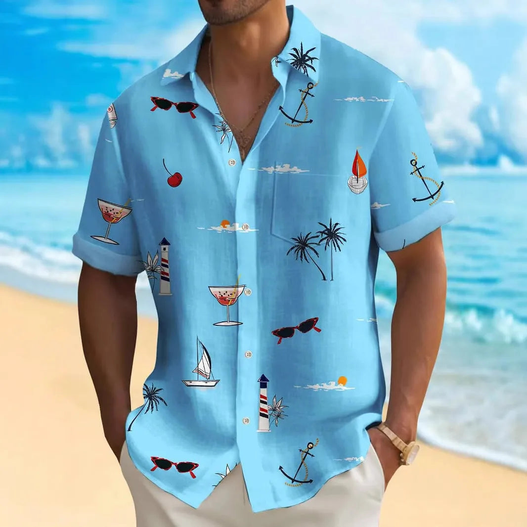 Man wearing a colourful loose-fit Hawaiian print short sleeve shirt on a beach.