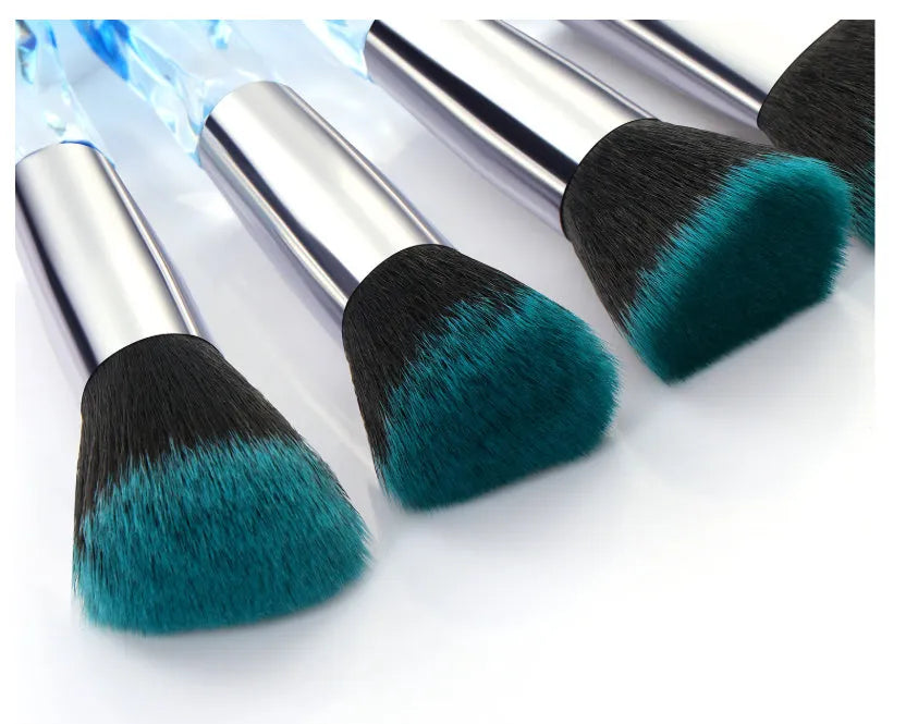 Ten crystal-handle foundation brushes with artificial fibre bristles in black, blue, red, and yellow colours.