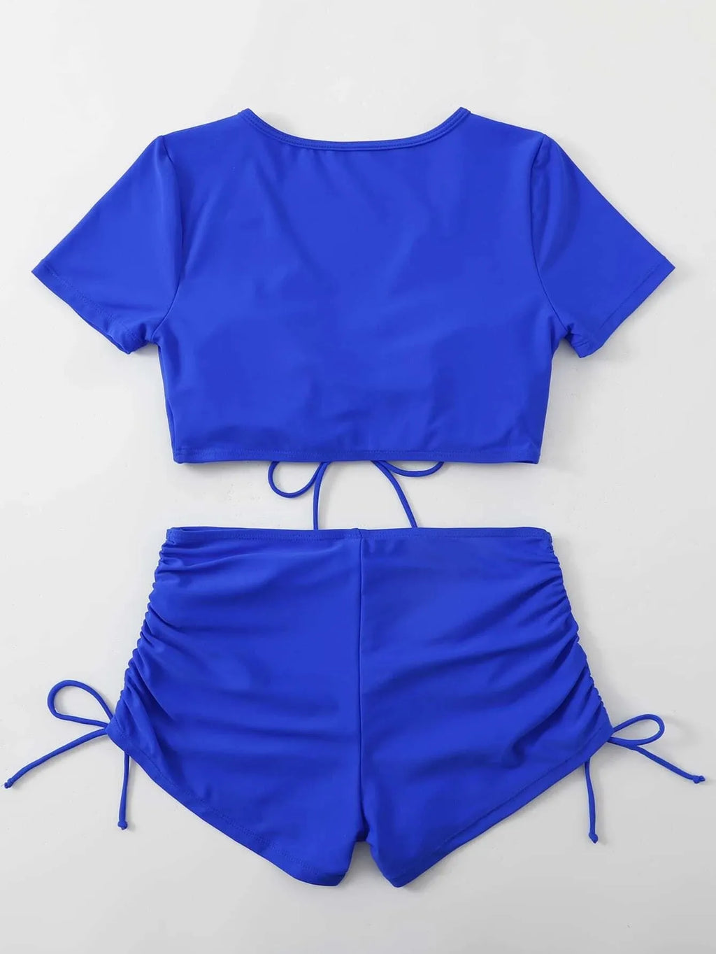 Women's black lace-up swimsuit with bow detail, showing top and shorts set.