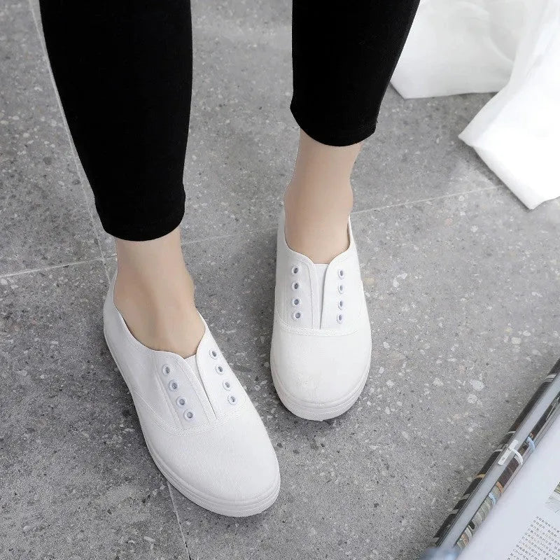 A pair of low-top canvas casual shoes on a white background, shown in one of the available colours.