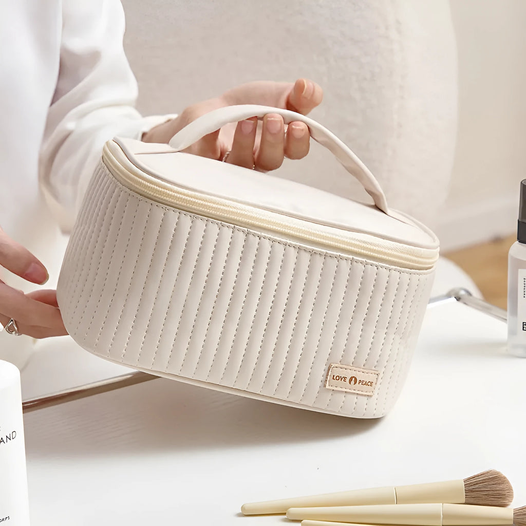 Open-top cake style makeup bag in PU leather, shown in beige, with dimensions 24cm by 16cm by 13cm.