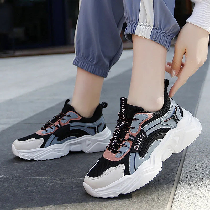 Women's white casual sports shoes with mesh upper, thick PU sole, and buckle detail