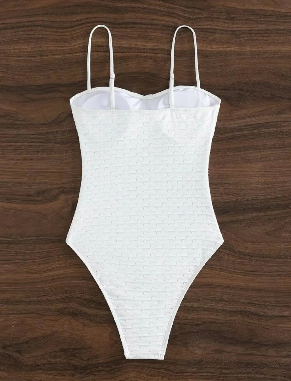 White women's one-piece swimsuit with a sling back design on a mannequin.