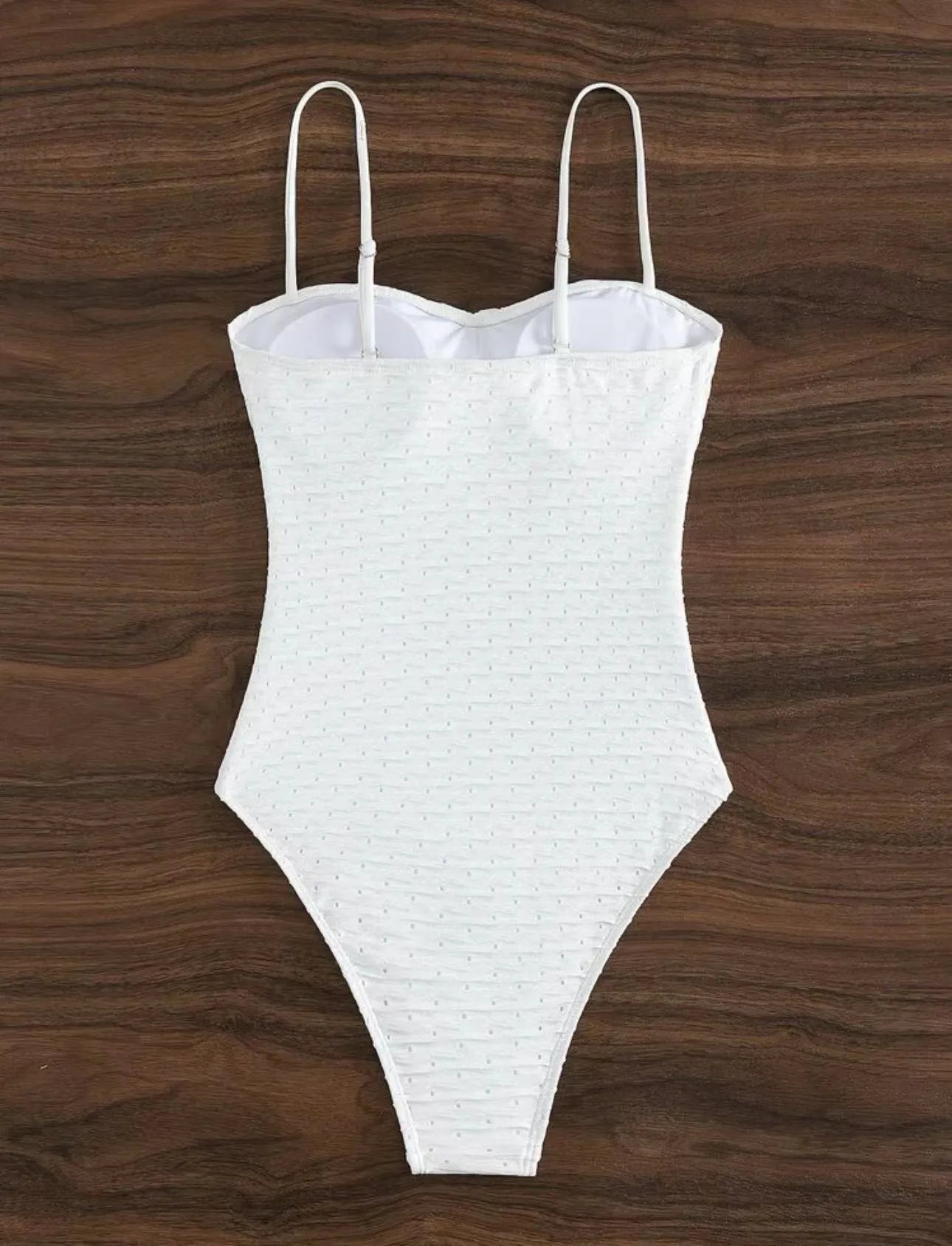 White women's one-piece swimsuit with a sling back design on a mannequin.