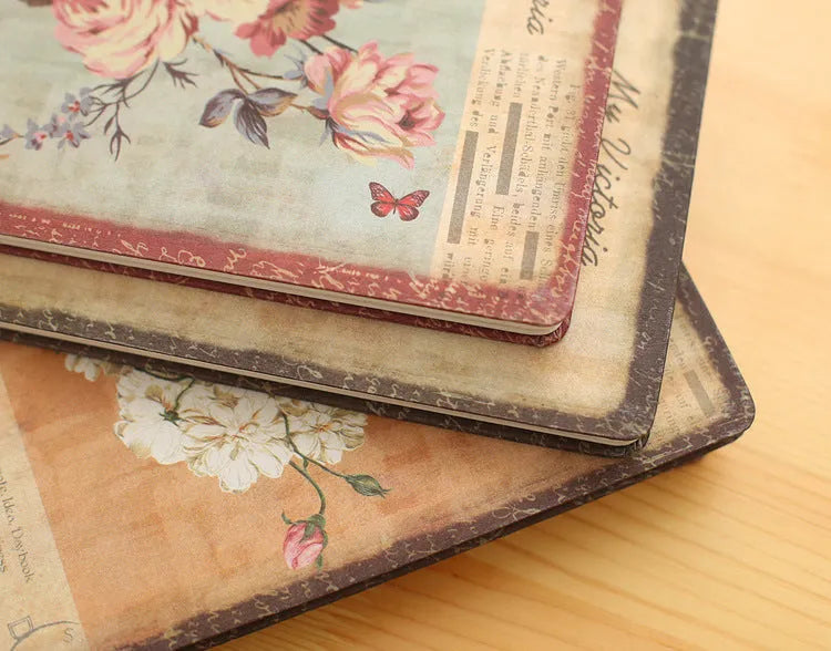 Hardcover notebook with retro floral cloth cover in Lily colour, showing 25K size next to 50K size comparison