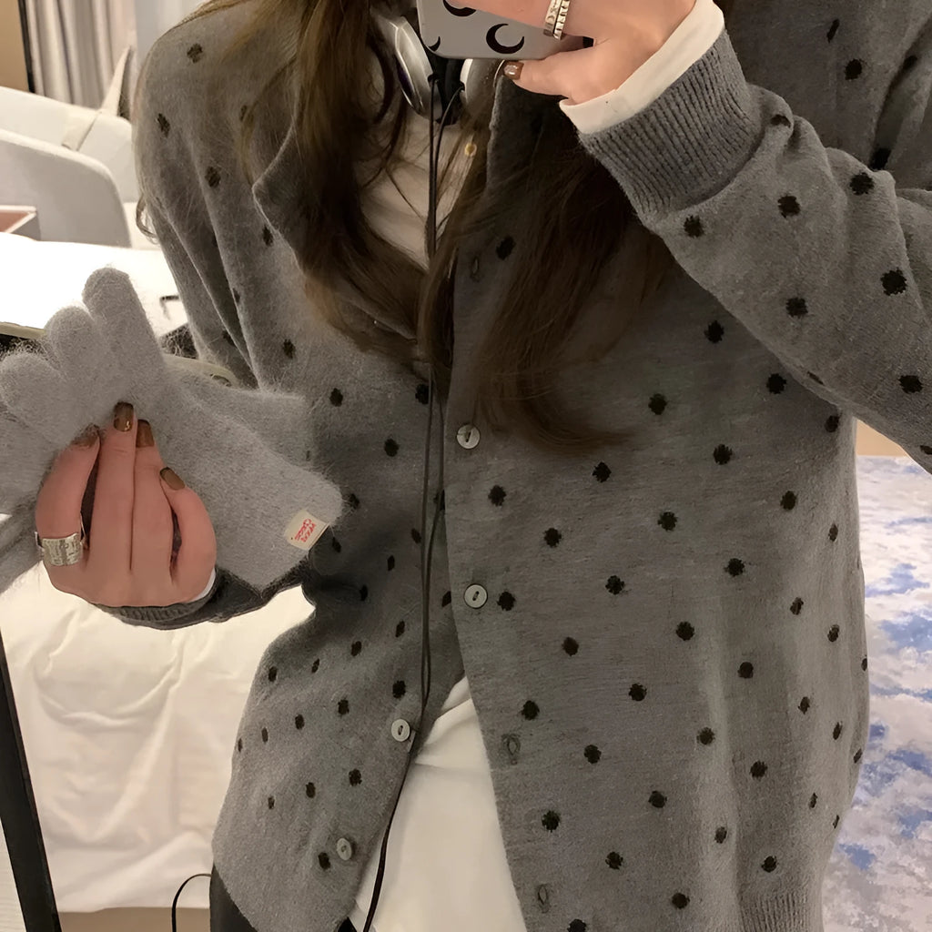 Gray women's loose-fit knitted cardigan with crocheted flower details on the front.