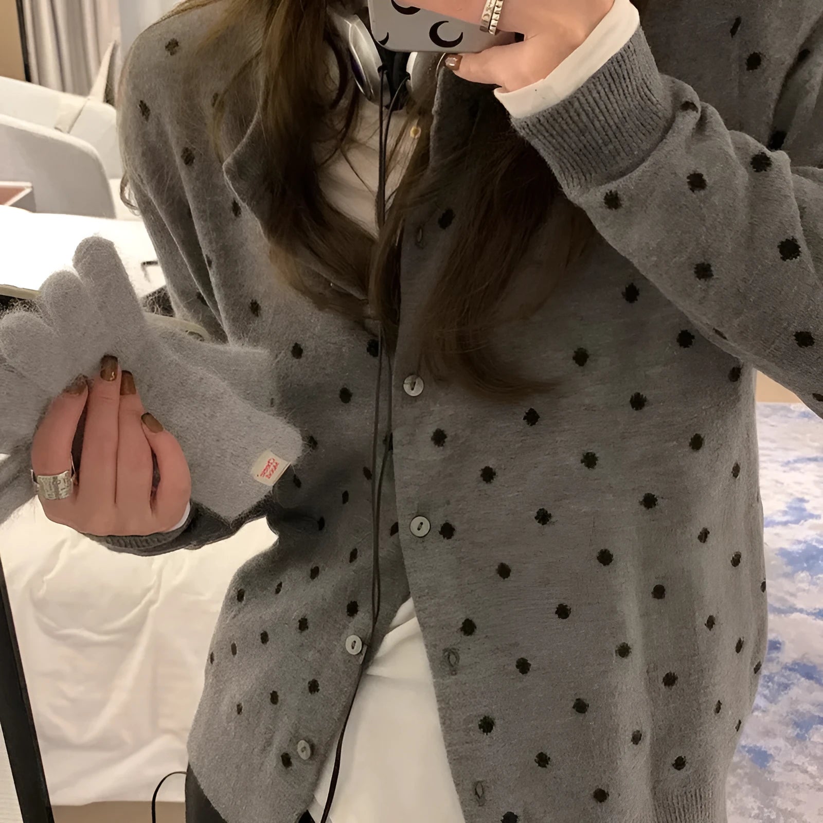 Gray women's loose-fit knitted cardigan with crocheted flower details on the front.
