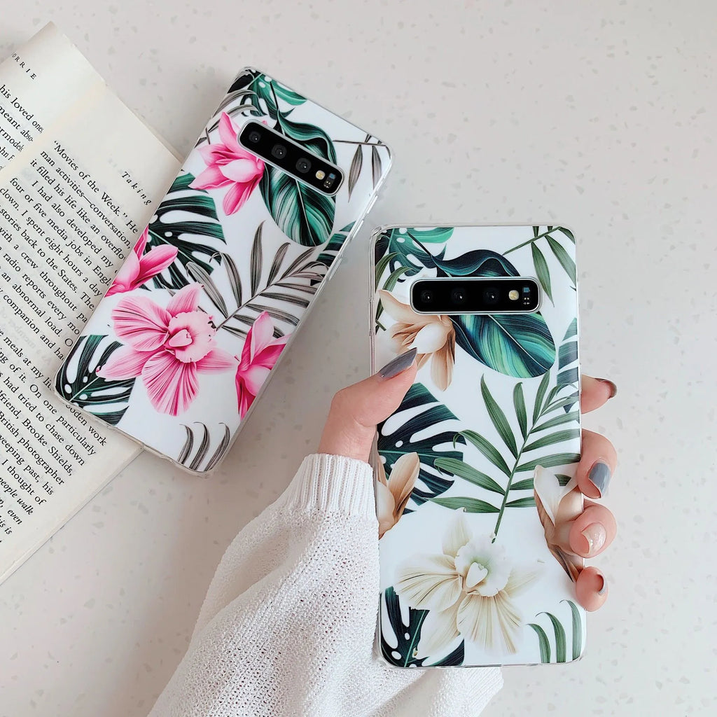 Samsung floral TPU phone case in safflower colour with green leaf design on a table.