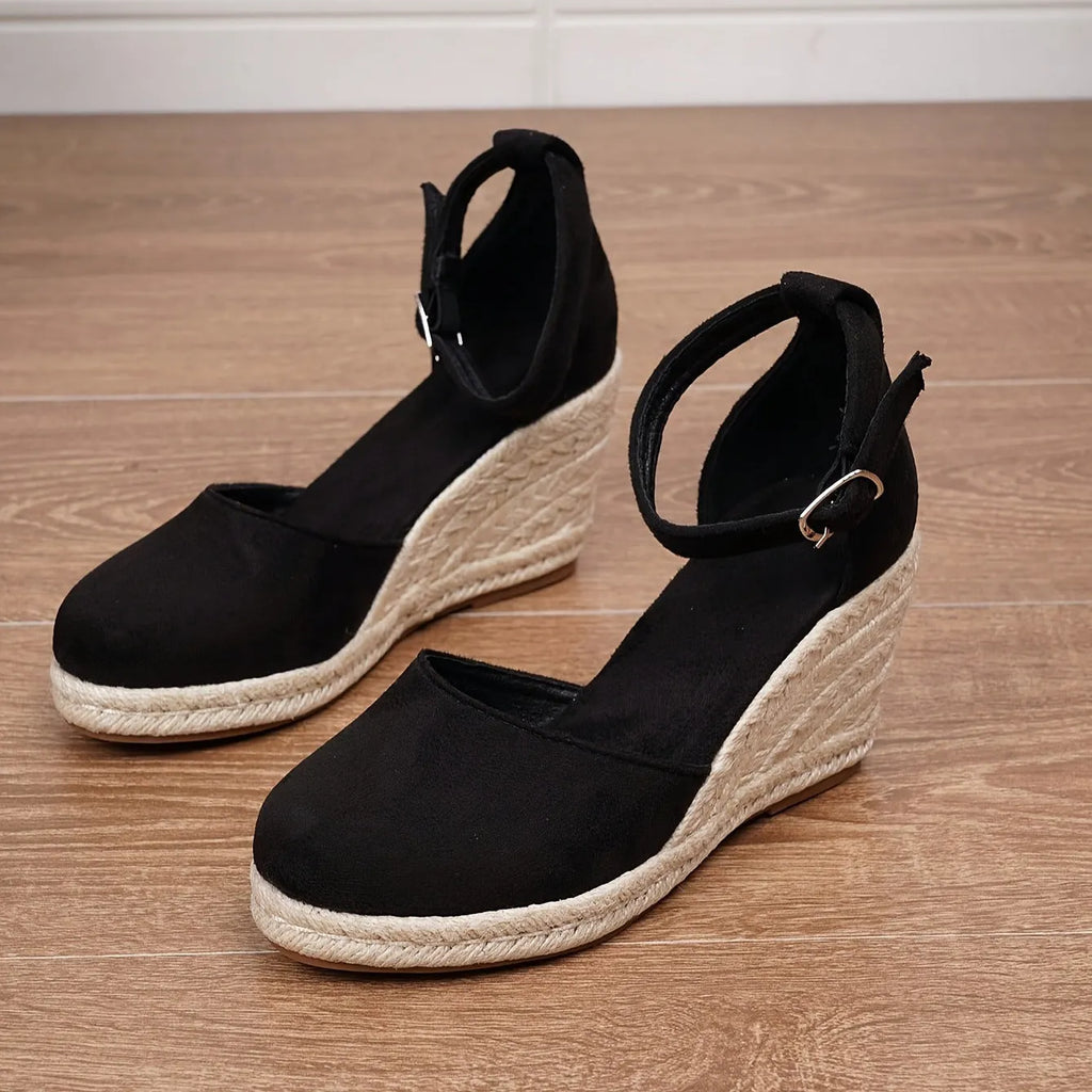 Women's apricot suede wedge sandals with a round toe and buckle strap on a rubber sole.