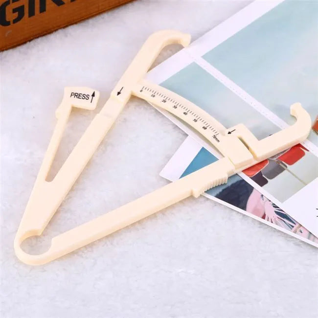 Transparent acrylic body fat caliper showing measurement scale up to 200mm