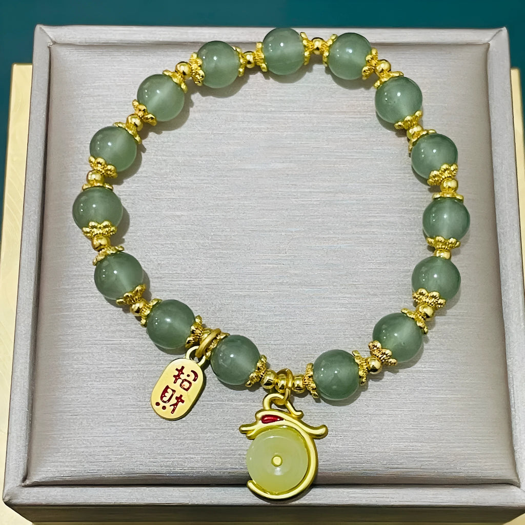 Handcrafted glass peace buckle bracelet with coloured glaze rabbit design on a white background.