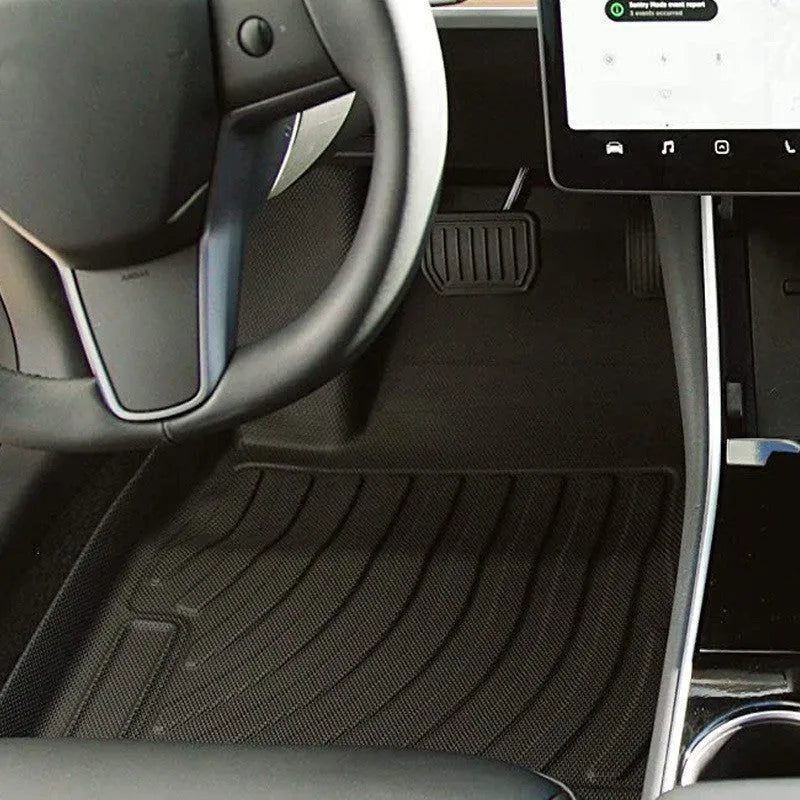 Custom rubber floor mats for Tesla cars, showing TPE footrest section and model-specific contours.