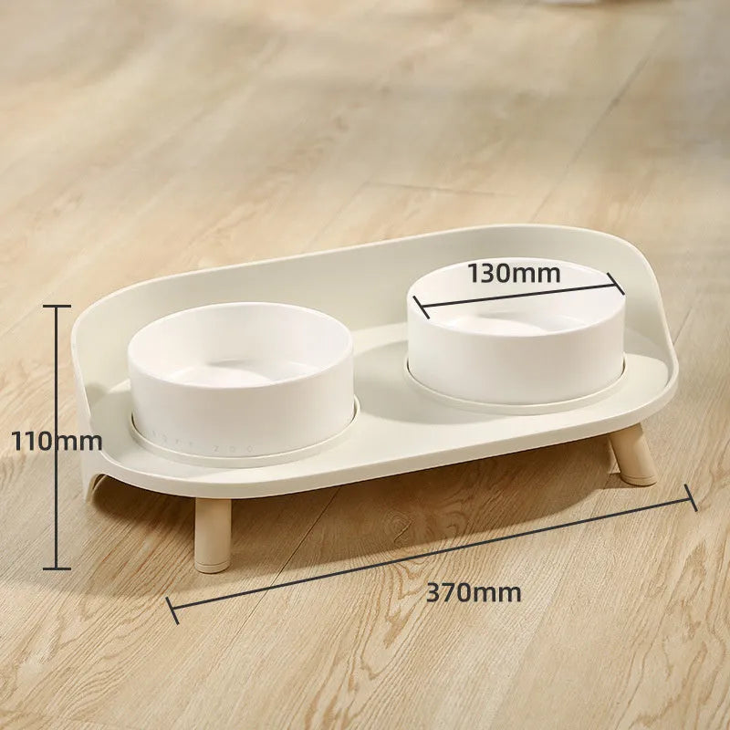 Green adjustable tilted double pet bowl for cats and dogs, showing separate food and water compartments.
