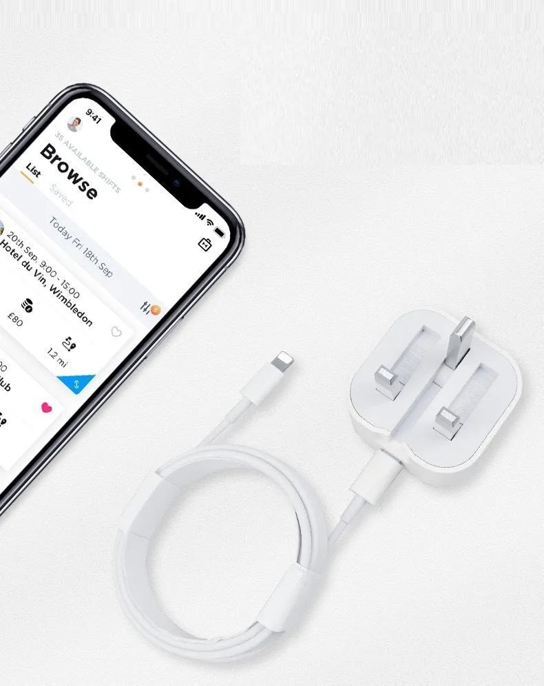 White 20W USB-C PD fast charger with UK plug and a coiled charging cable.