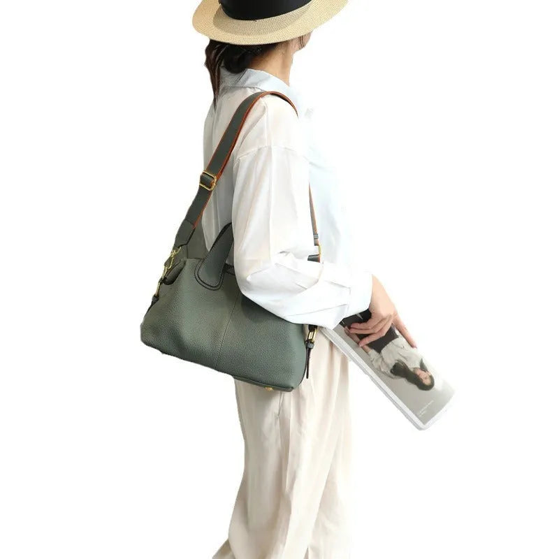 Women's leather cross-body shoulder bag in horizontal square shape with multiple internal zipped compartments