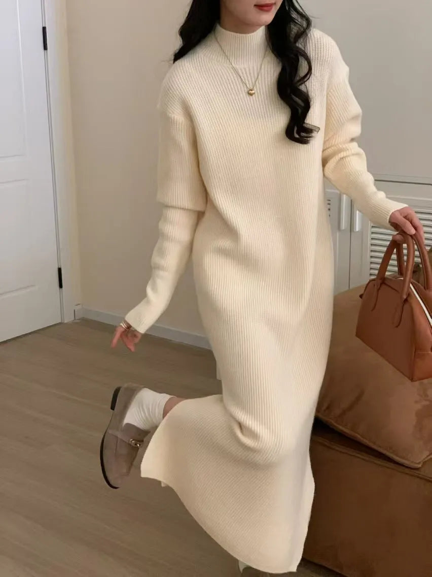 Woman wearing a milky white half turtleneck acrylic knit dress with a high waist and overknee A-line skirt.