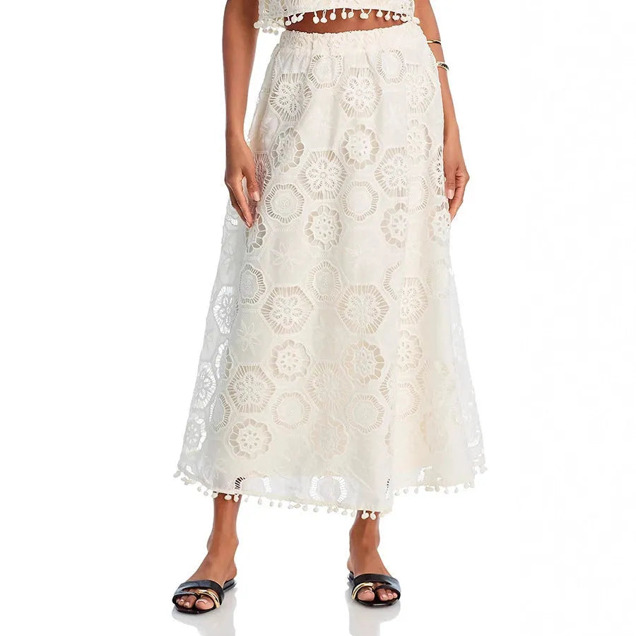 White women's two-piece suit with sleeveless top and embroidered long skirt