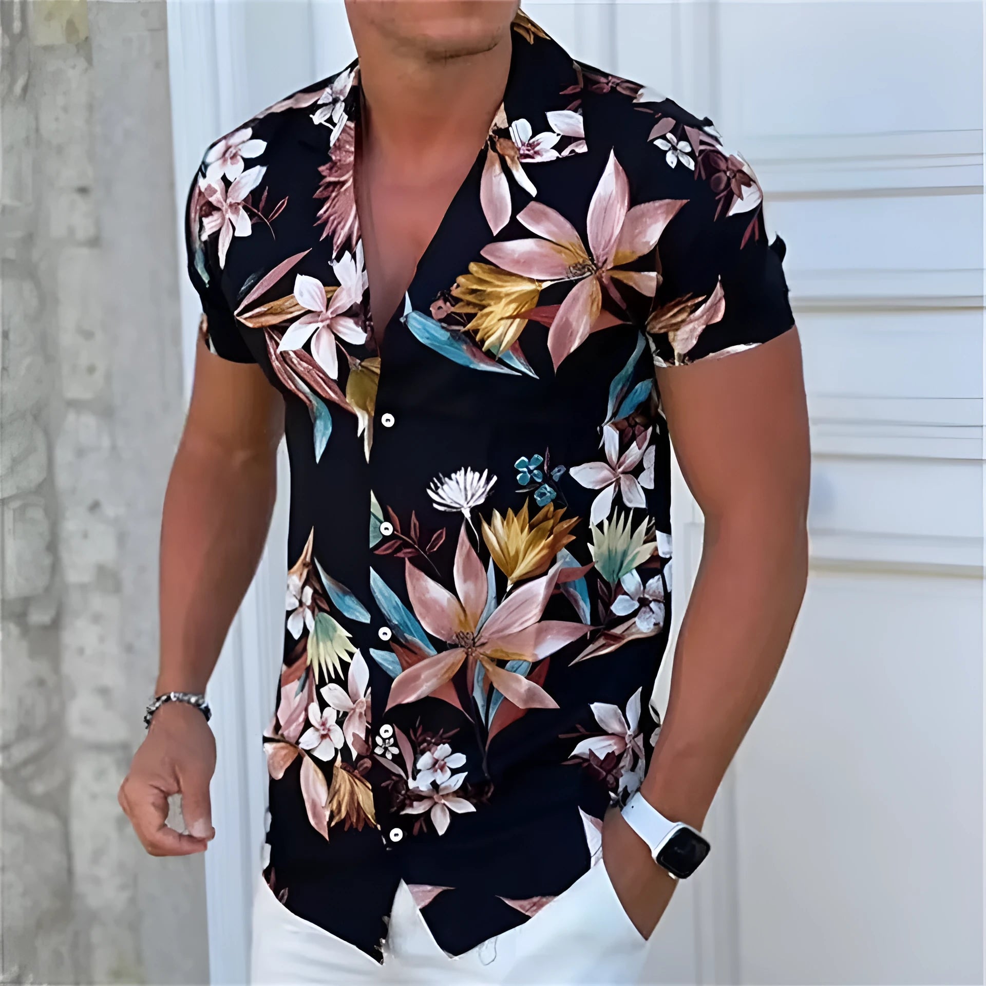 Man wearing a loose-fit floral print short sleeve beach shirt in a casual setting.