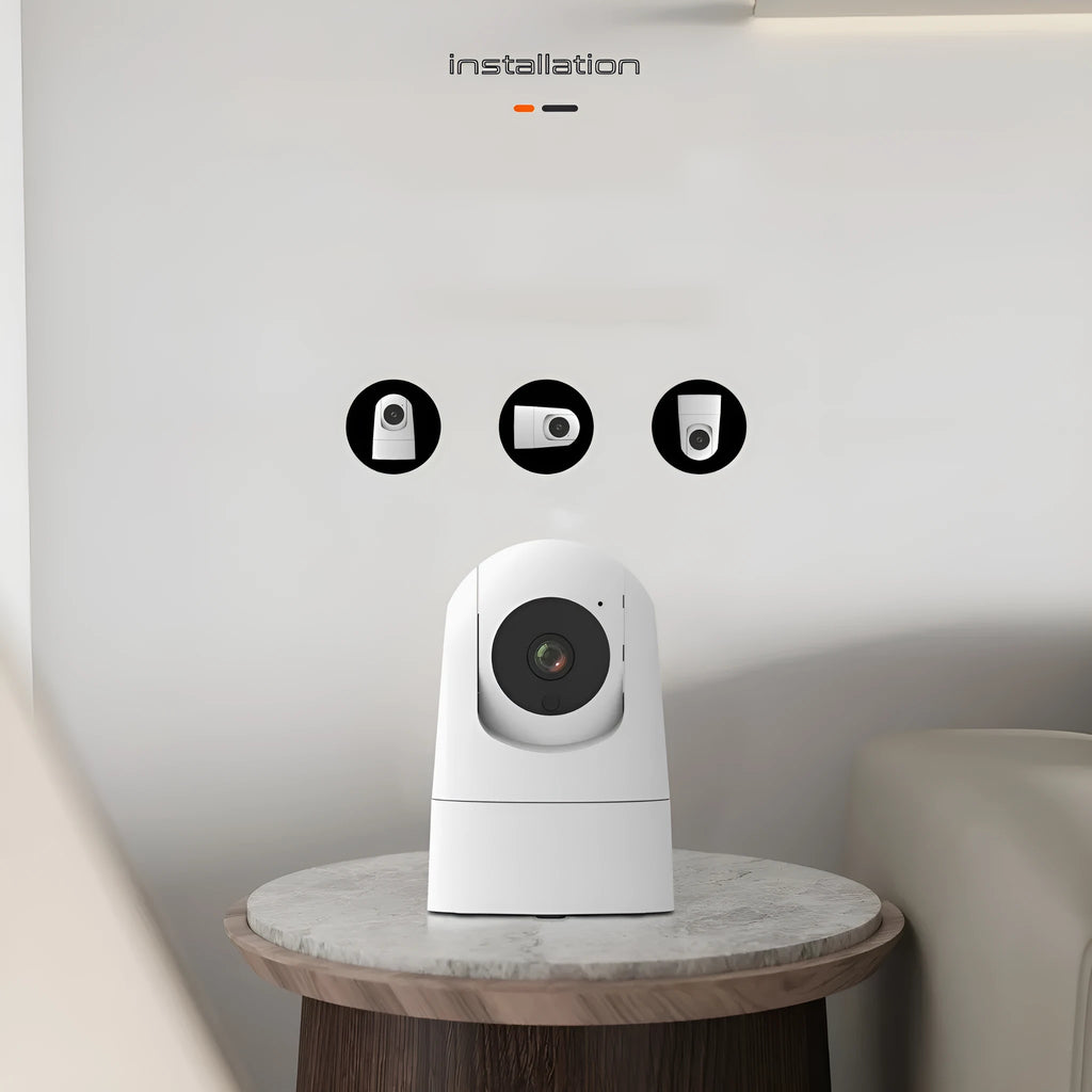 White indoor security camera with adjustable lens on a desk next to its power adapter.