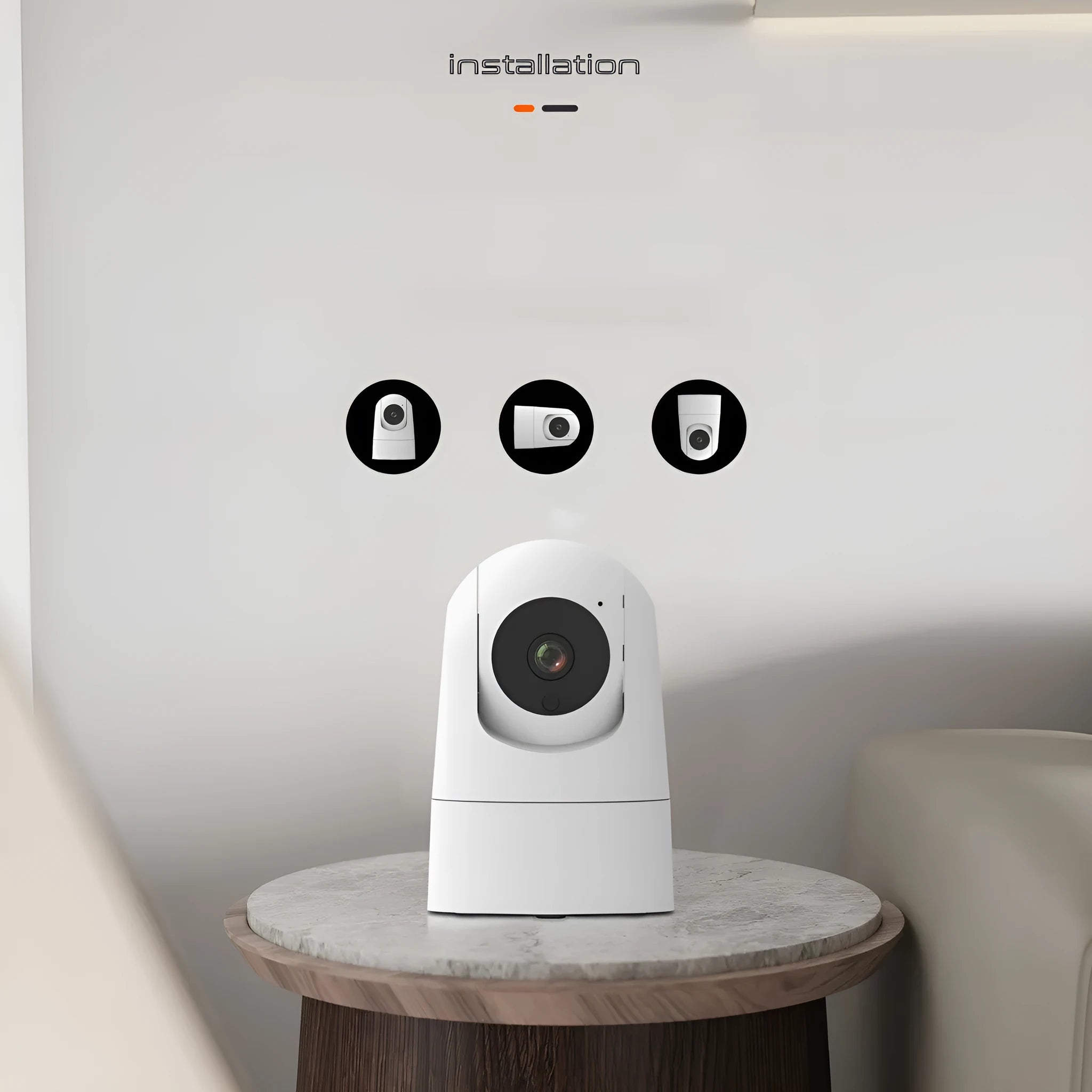 White indoor security camera with adjustable lens on a desk next to its power adapter.