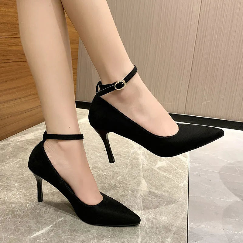 Women's black stiletto heel pump shoes with buckle detail on side